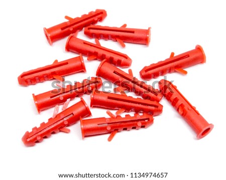 Red plastic anchors isolated on white background.