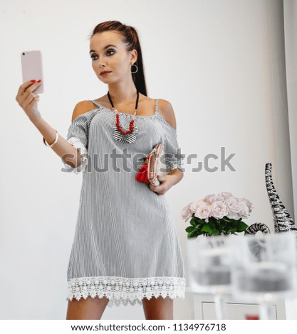 Slim young woman in home interior with window. 