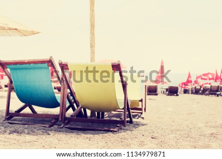 Beach beach background with chairs near the sea. Summer holiday and vacation concept
