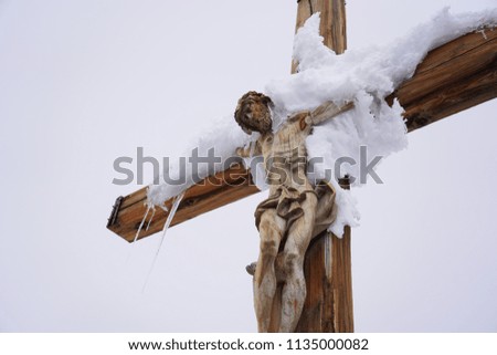 Concept of peace and cold. The jesus christ wood sculpture on the top of moutian in switzerland.