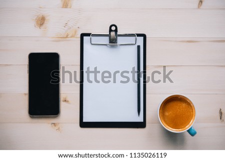 Top view office table with notepad and smart phone, coffee.copy space for text or design