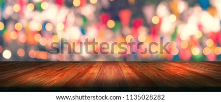 top desk with blur restaurant background,long wooden table and blurred bokeh of night street background Royalty-Free Stock Photo #1135028282