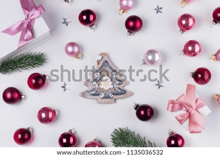 Christmas flat lay pattern with christmas tree, pink abd violet glass balls and gift box