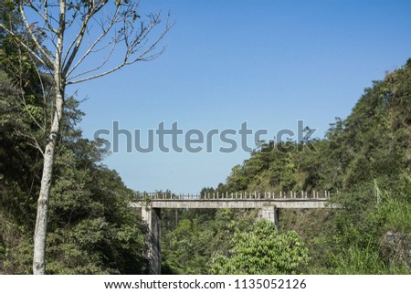 Kalikuning old bridge in Yogyakarta, Indonesia with green environment and blue sky under the slope of Merapi mountain