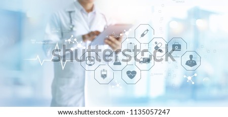 Medicine doctor and stethoscope using tablet with icon medical network connection on virtual screen interface in hospital background. Modern medical technology concept.