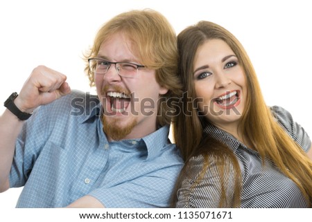 Ginger nerdy man and beautiful teen woman having fun together posing for picture.
