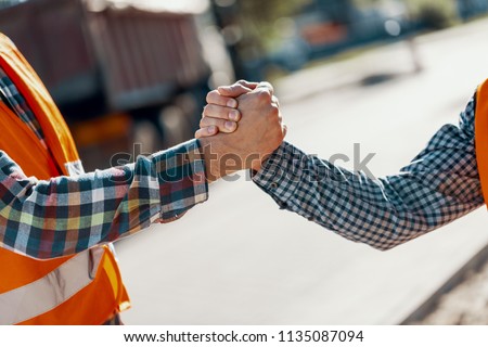 Close-up of two workers shaking hands after completing a job Royalty-Free Stock Photo #1135087094