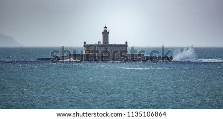 Long shot of Fort in the ocean near Lisbon with waves breaking Royalty-Free Stock Photo #1135106864