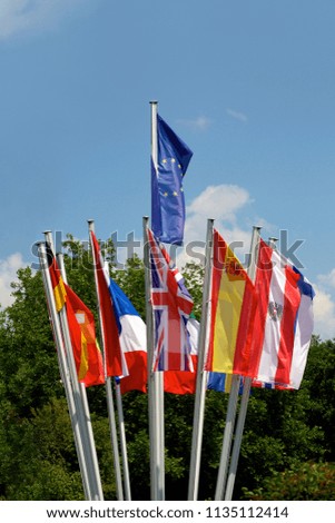 EU Flags of different Eurozone countries on blue sky