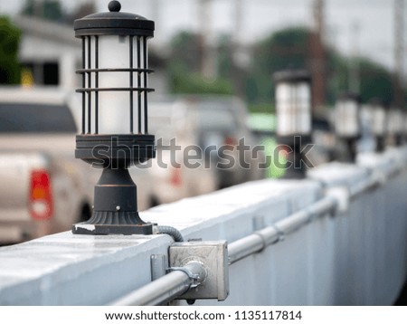 Close-up wall lamp installed on concrete and steel pipe electric wire used for outdoor wiring