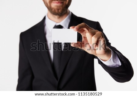 partial view of businessman showing blank business card isolated on white background 