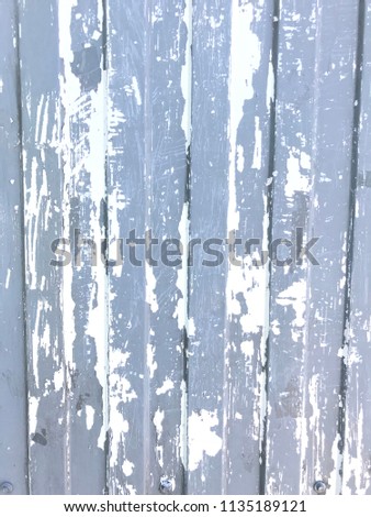Vertical photo of a gray-blue wall with shabby paint. texture. Background.