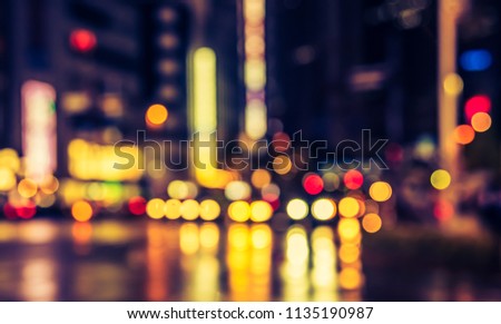 Abstract Blurred image of  street in night time with bokeh for background usage. (vintage tone)