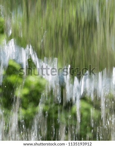 Wall of moving water in nature as background, blur