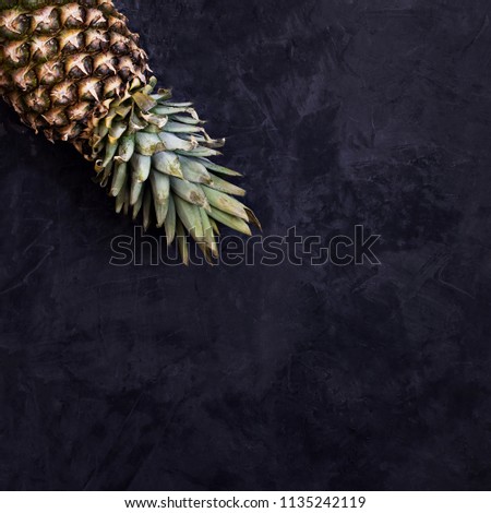 Fresh pineapple on a dark background