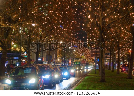 Europe festive Christmas illumination city many cars and autobus share the road at night. Waiting for the traffic light turn green to cross the road.Christmas street light.