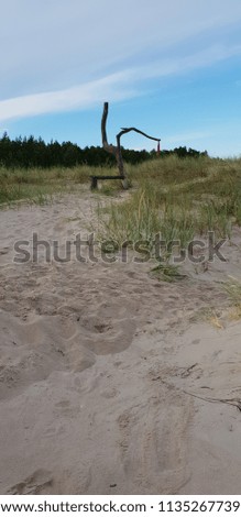 Wooden bench in seaside of Baltic sea. View to beach