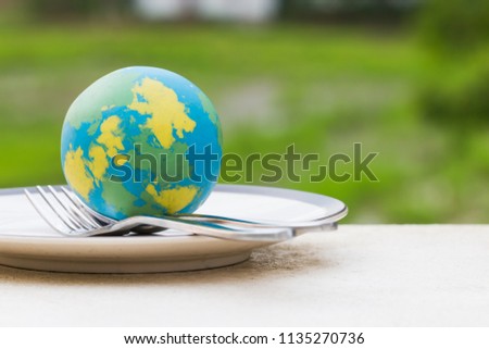 Globe model placed on plate with fork spoon for serve menu in famous hotels. International cuisine is practiced around the world often associated with specific region country. World food inter concept Royalty-Free Stock Photo #1135270736