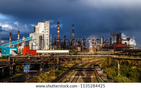 Industrial landscape. Industrial plant and railroad before the thunderstorm.
