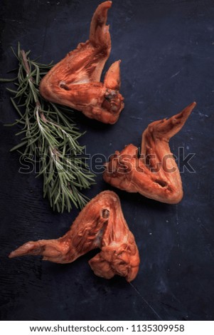 Smoked Chicken Wings ready to eat. Chicken Wings on dark background . Top view. Flat lay.