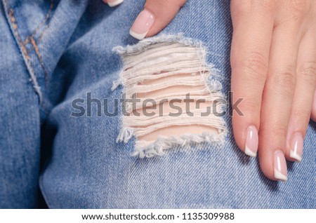 Woman in torn blue jeans macro fashion casual textile fabric fashion