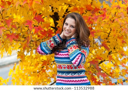 attractive teen girl in front of the colorful autumn leaves