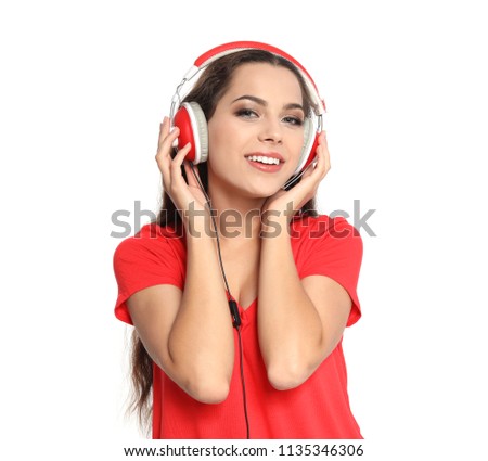 Young woman listening to Christmas music on white background