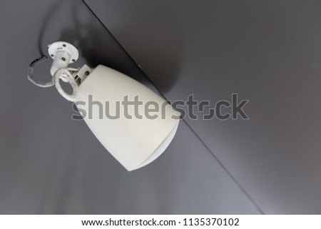 white modern style loudspeaker hanging at ceiling.