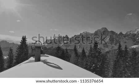 Snowy roof top with a beautiful view to the mountains of South Tyrol.