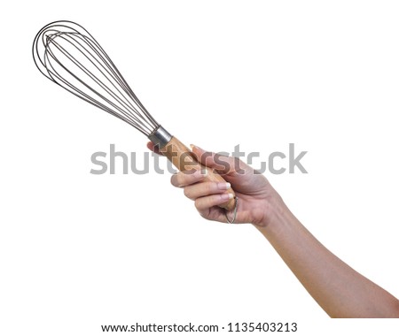 Woman hand holding whisk egg for beater isolated on white background Royalty-Free Stock Photo #1135403213