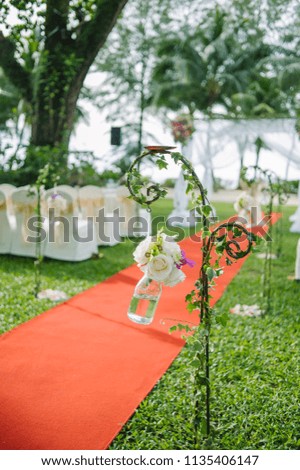 beautiful garden wedding celebration, all setup of flowers and red carpet and decoration