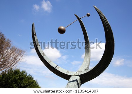 Sundial in the park. Sundial devices that tells the time of day when there is sunlight by the apparent position of the Sun in the sky.