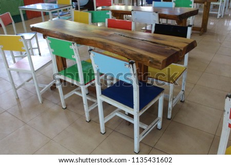 Multi-colored chairs and dining tables in primary schools in Thailand.