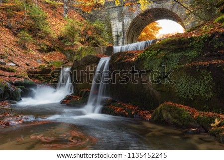 Autumn waterfalls near Sitovo, Plovdiv, Bulgaria. Beautiful cascades of water with fallen yellow leaves.