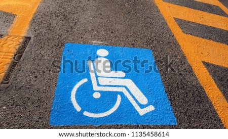 Wheelchair Handicap Sign on dark asphalt road street background- handicap parking place