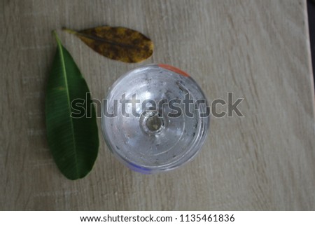 The top view of a cold glass on a gray wooden table.
