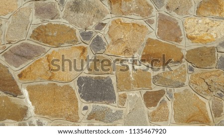 Natural stone. The wall is made of natural sandstone. Stone trim. Decorative rock. Vintage background. Decorative wall sandstone