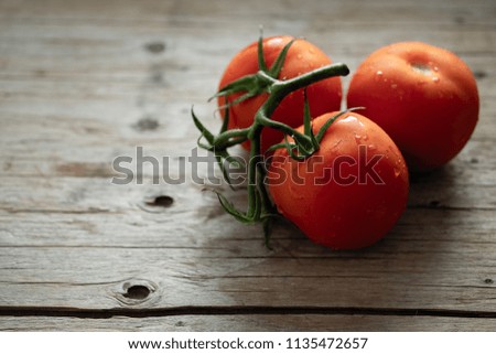 natural red tomatoes, cherry tomatoes on a wooden background