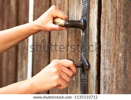 locking a big gate to a property with people stock photography stock photo