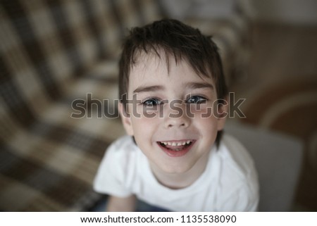 Toddler child happy on the couch in the real room at home, lifestyles and toning