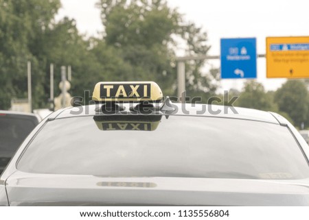 Taxi sign on a car in traffic jam