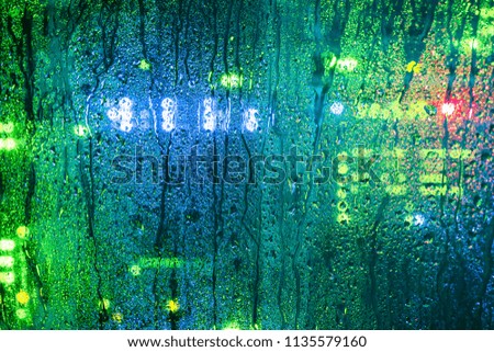 Drops on the glass wall of the server room. Moisture and water in the computer data center. Abstract background