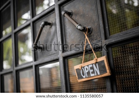 Open coffee shop sign on door