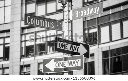 Black and white picture of Broadway and Columbus Circle street name signs,  New York City, USA.