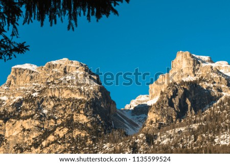 Mountain peak with shadow, sun and sky
