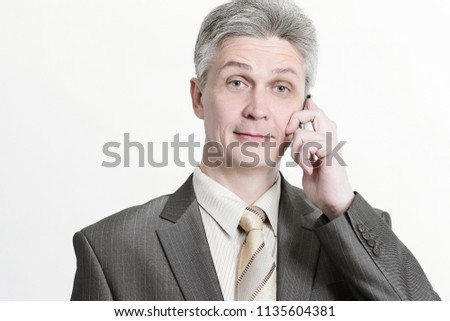 senior businessman talking on mobile phone.isolated on a white
