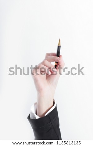 closeup of female hand with a pencil pointing at copy space