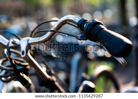 Rusty and old bike with a cobweb or spider web on the right handle bar