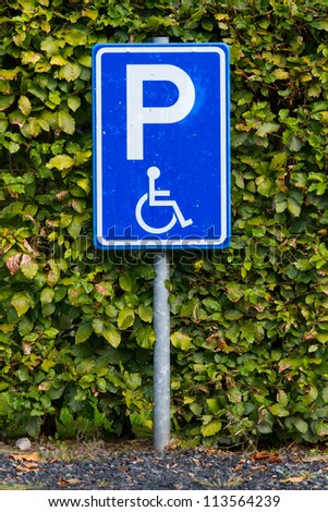 Close-up of a dirty parking sign for disable people