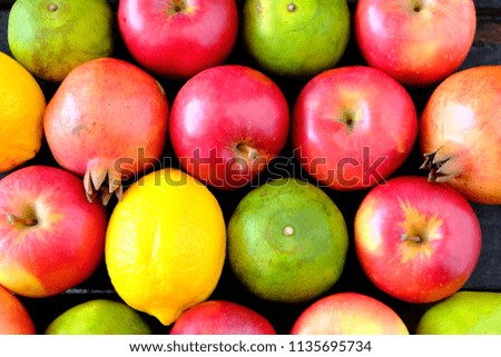 Mixed fruits background. Healthy eating. Background of healthy fresh fruits. pomegranate tangerine, apple, lemon